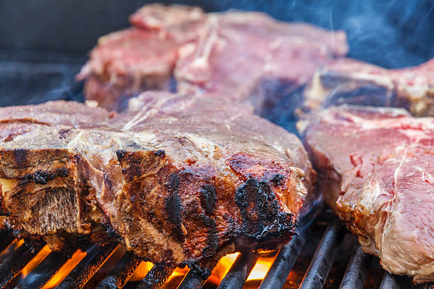 istock T-bone Steaks  on the BBQ Grill 174871767