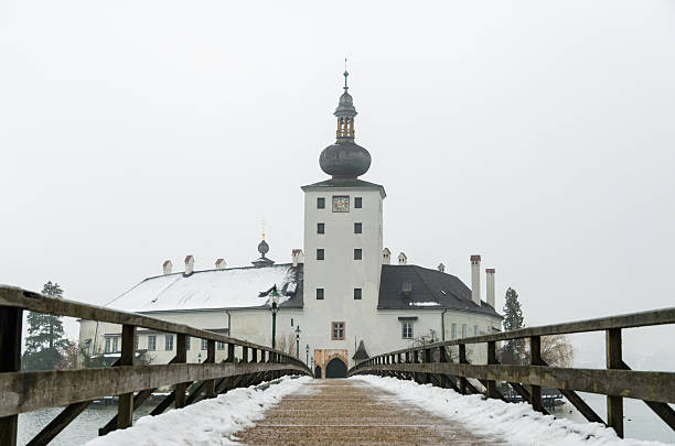 Bridge to Seeschloss Ort Wonderful capture of the old church Seeschloss Ort in Gmunden on a cold and snowy January morning. The area of Salzkammergut is a world heritage site. The Seeschloss was also royal residence of Adam von Herberstorff, who died September 1629 in this building. Since 1995, the Seeschloss is a public building. seeschloss stock pictures, royalty-free photos & images