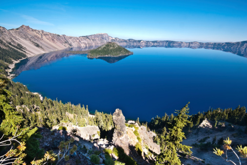 Crater Lake exists in the blown-out caldera of a once mighty volcano known as Mount Mazama. This view of the lake and Wizard Island was taken from the Rim Trail in Crater Lake National Park, Oregon, USA.