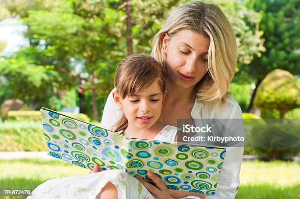 Reading In The Park Stock Photo - Download Image Now - 4-5 Years, Activity, Adult