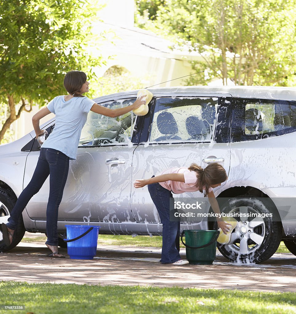 Two Girls Washing Car Together Two Girls Outside Washing Car Together. Car Wash Stock Photo
