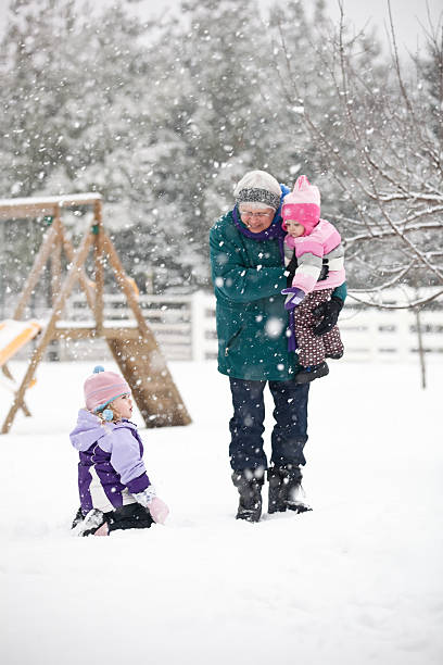 istock Girls Playing in Snow with Grandma 174873371