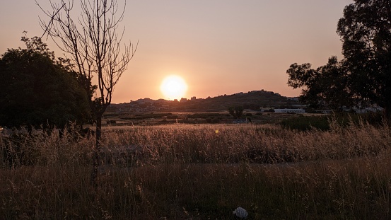 Sunset in the Vicinity of Lisbon in the Amador area The sun hides behind the hills photo