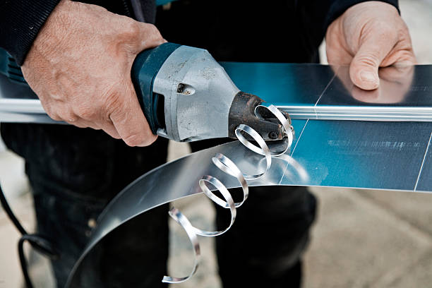 istock cutting a sheet of metal for under floor heating system 174873923