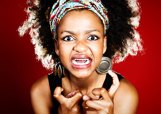 istock Woman grimacing with clenched fists has really lost her temper! 174874560