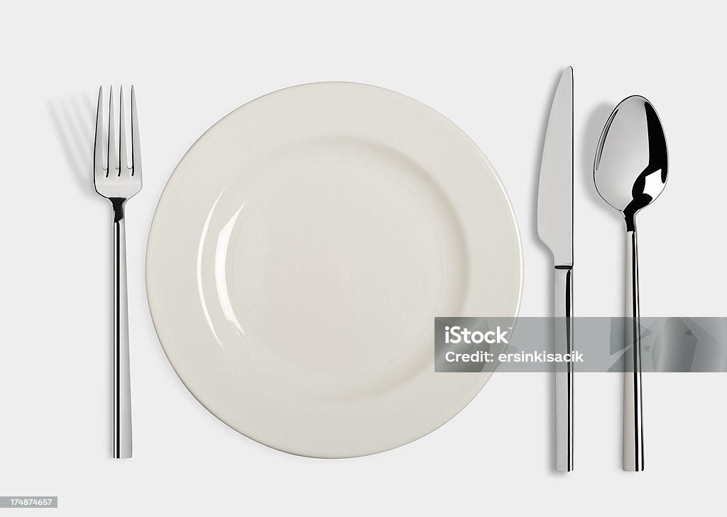 Table Setting With Clipping paths "Empty white plates and fork,spoon and table knife isolated on white background. Table setting Include clipping paths.For similar images" Place Setting Stock Photo