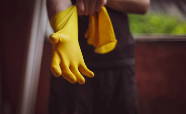 istock Caucasian male builder wears yellow gloves. 1748746864