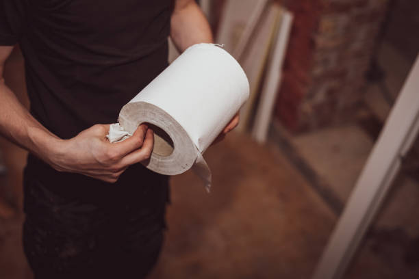 istock Caucasian male builder holds a paper towel in his hands. 1748746885