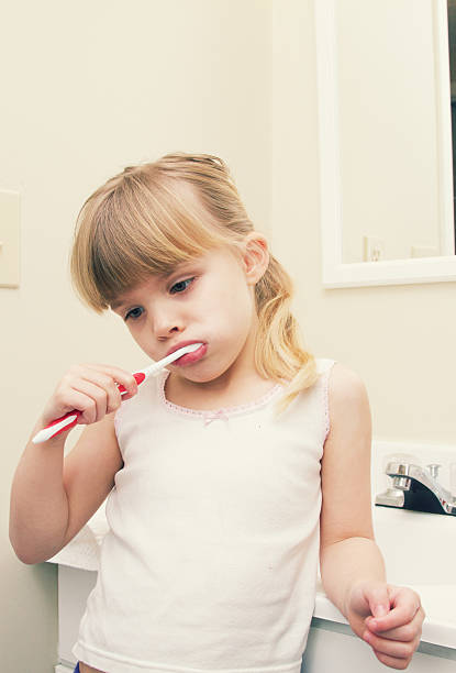 istock Little Girl Brushing Teeth 174874728