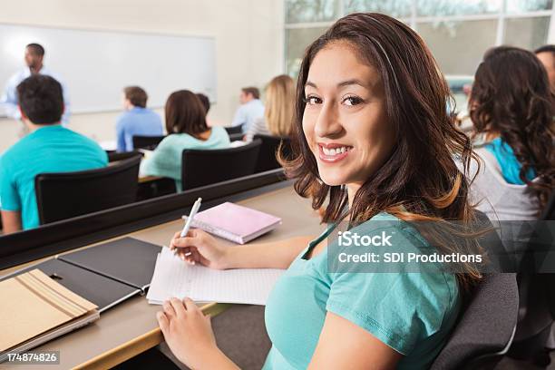 College Age Girl Taking Notes During Professors Lecture In Class Stock Photo - Download Image Now