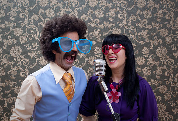 istock Two friends in seventies style singing on old fashioned microphone 174875274