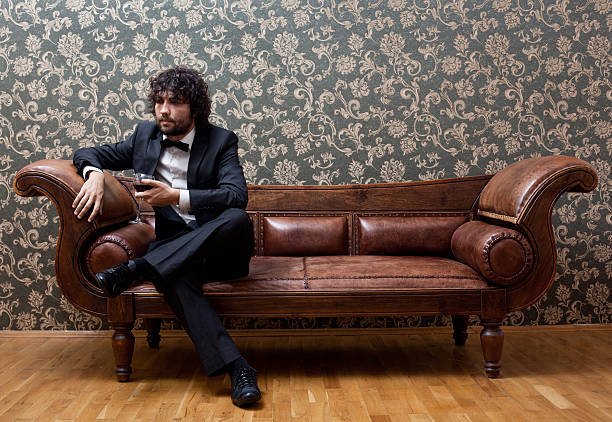 istock Lonely man sitting on sofa right after party 174875391