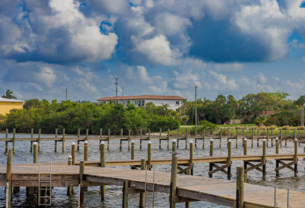 istock Blue skies with heavy while clouds above a beautiful body of water with multiple water decks 1748757846