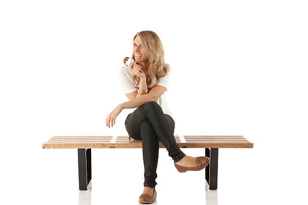 istock Smiling woman sitting on a bench with ice cream 174876133