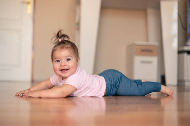 istock Seven-month-old baby is lying on the floor and smiling. 1748763995