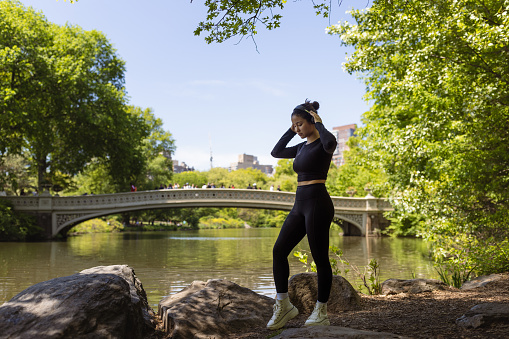 Cute multiracial girl jogging in Central Park, NYC