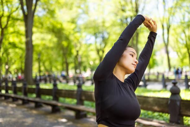 Cute multiracial girl jogging in Central Park, NYC