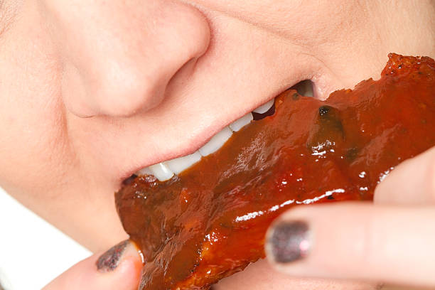 istock Woman eating spareribs 174877074