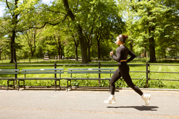 Multiracial girl jogging in Central Park stock photo