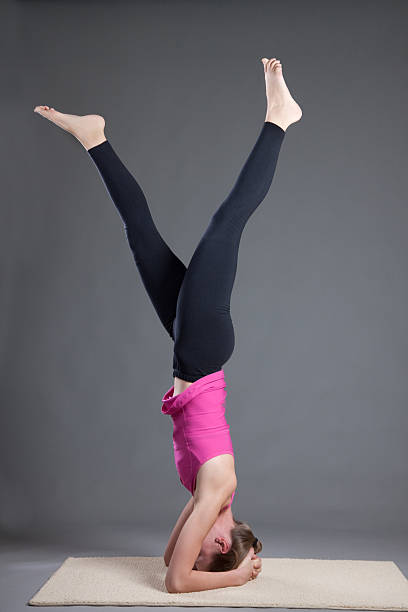 istock Young Woman Doing Yoga Headstand 174877161