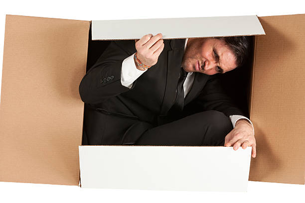 istock Businessman packed in a cardboard box 174877406