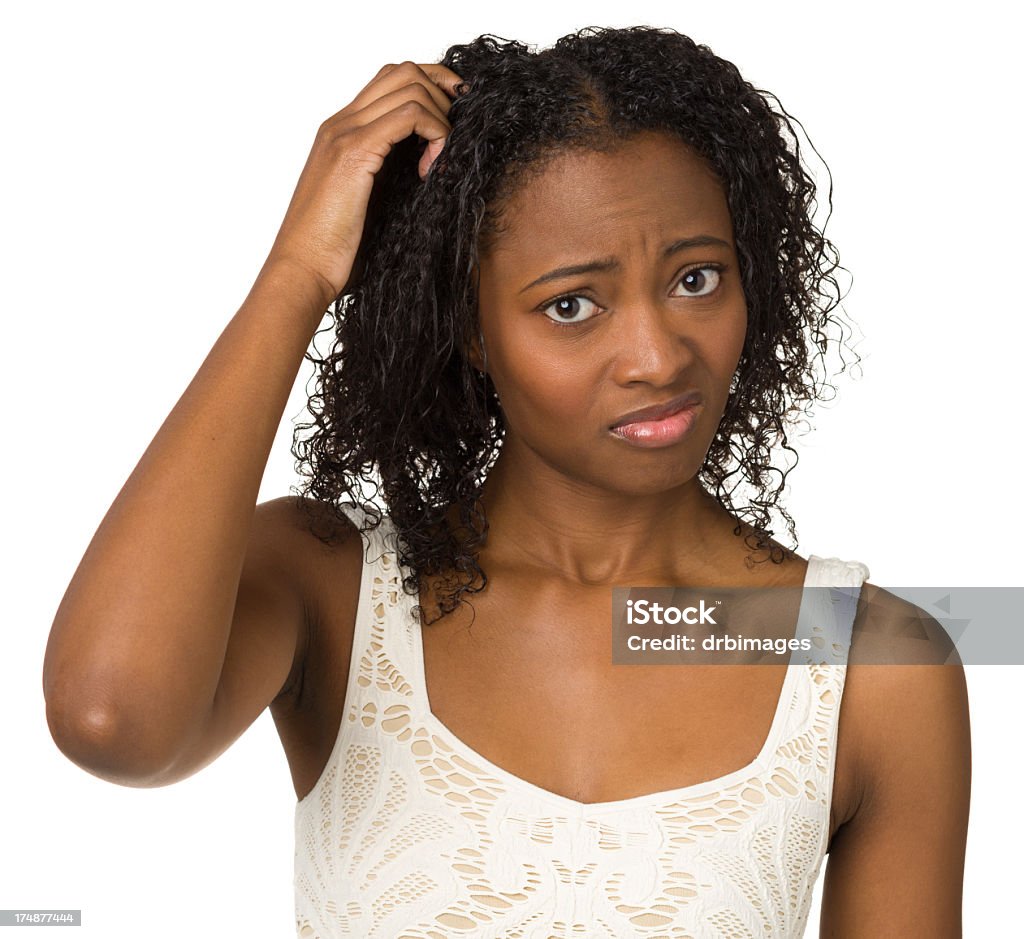 Uncertain Young Woman Scratching Her Head Portrait of a young woman on a white background. One Woman Only Stock Photo