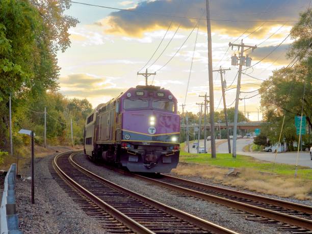 mbta commuter train crosses sutton street near downtown north andover - railroad crossing mbta train railroad track imagens e fotografias de stock