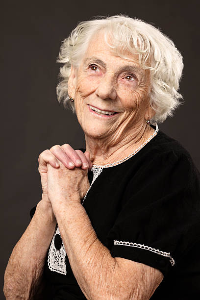 istock Senior woman praying 174878007