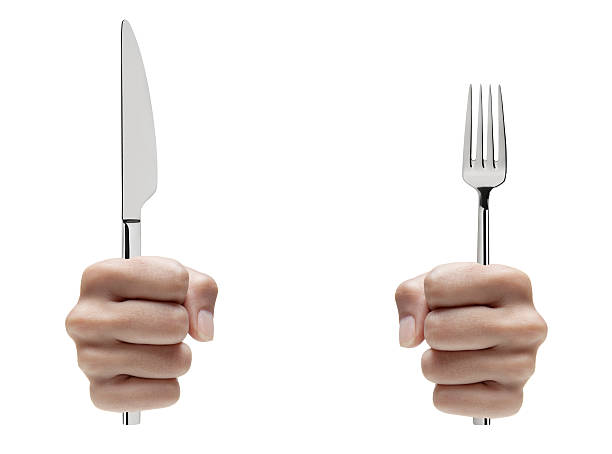 Hands Holding Fork and Knife stock photo