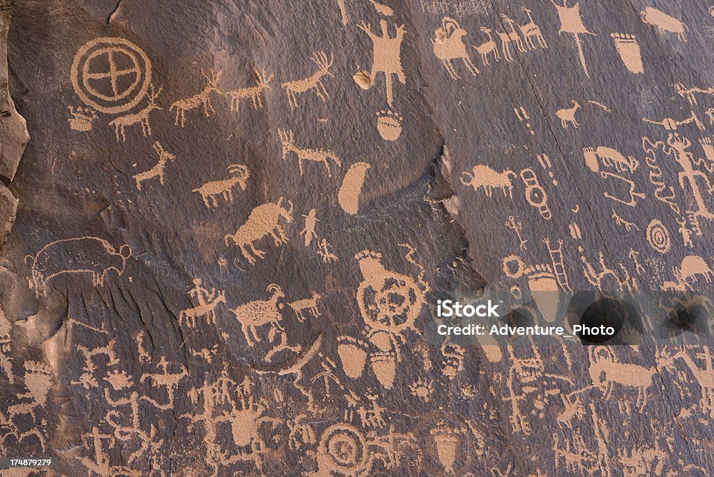 Newspaper Rock Anasazi Indian Petroglyphs Ancient pictorial images carved into rock by the Anasazi Indians who dwelled here 900 years ago.  Captured as a 14-bit Raw file. Edited in 16-bit ProPhoto RGB color space. Utah Stock Photo