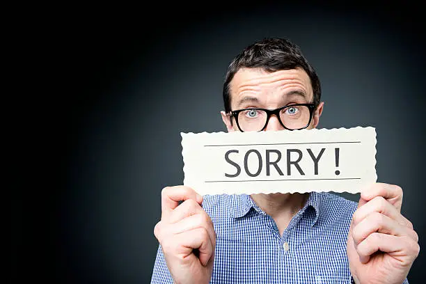 Middle aged man saying sorry.