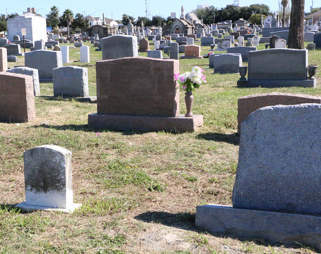 Calgary, Alberta, Canada â October 9, 2022: Tombstones in a Chinese graveyard on the hill in Calgary with a blue sky in the background