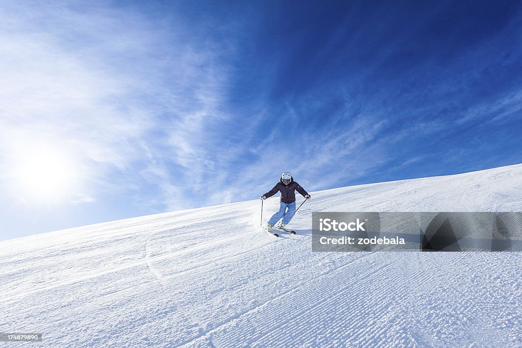 Sciatore femminile durante una giornata di sole - Foto stock royalty-free di Inverno