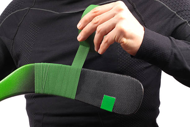 istock man linking hockey tape over the stick 174880055