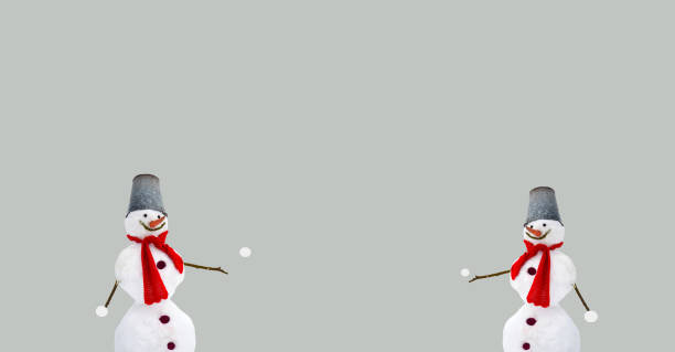 Winter, Christmas themed composition with two snowmen playing with snowballs