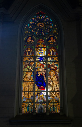 Stained glass of a catholic church in belo horizonte brazil showing a saints pops and holy creatures with Jesus scene