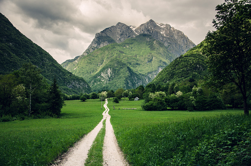 Dramatic scenery of hiking trail below the high mountain peaks in Koritnica Valley near Bovec, Slovenia, Europe