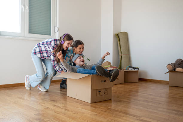 istock two girls push a boy in a box 1748888043