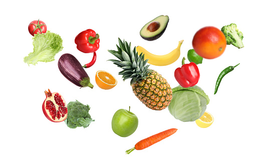 Top view of various multicolored fruits and vegetables disposed at the borders of the image on a frame shape leaving a useful copy space at the center on white background