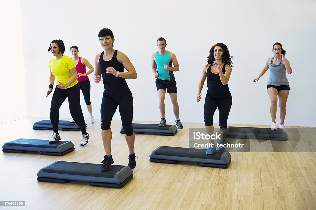 Medium group of people doing step aerobics Medium group of people excercising in the gym Step Aerobics Stock Photo