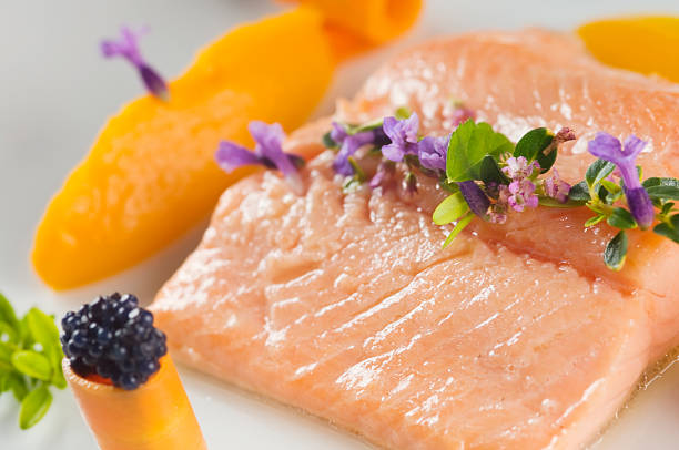 Delicious boiled salmon Boiled salmon with herbs and served with carrot puree. Shallow dof. bull trout stock pictures, royalty-free photos & images