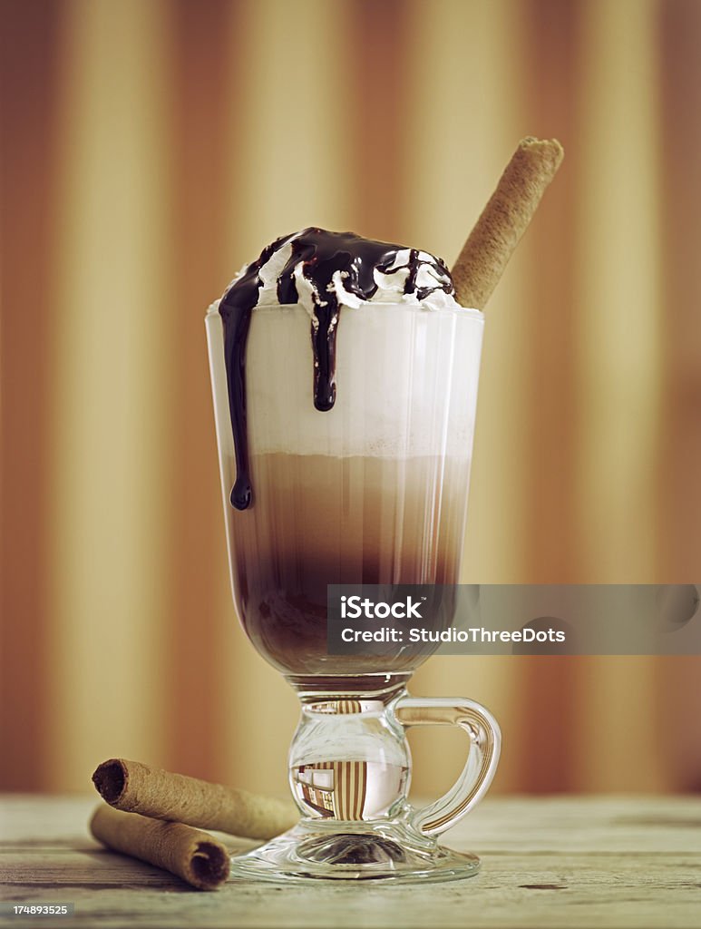 Latte Machiato With Whipped Cream "A glass of latte machiato with whipped cream, chocolate topping and waver rolls." Irish Coffee Stock Photo