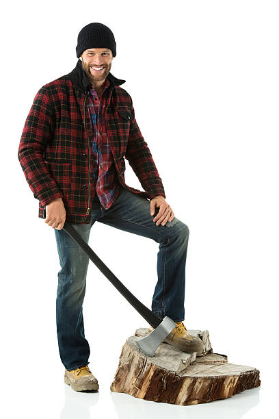 istock Smiling lumberman standing on tree stump with an axe 174893566