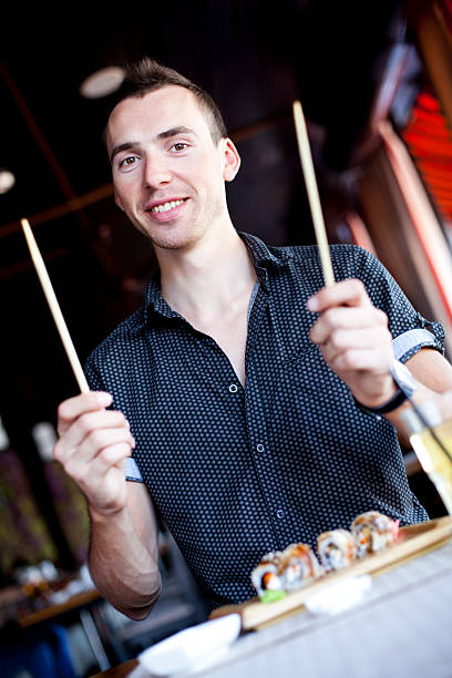 istock Young man Ready to Eat Sushi 174893725