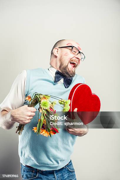 Humorous Man Covered In Kisses And Holding Bouquet Of Flowers Stock Photo - Download Image Now