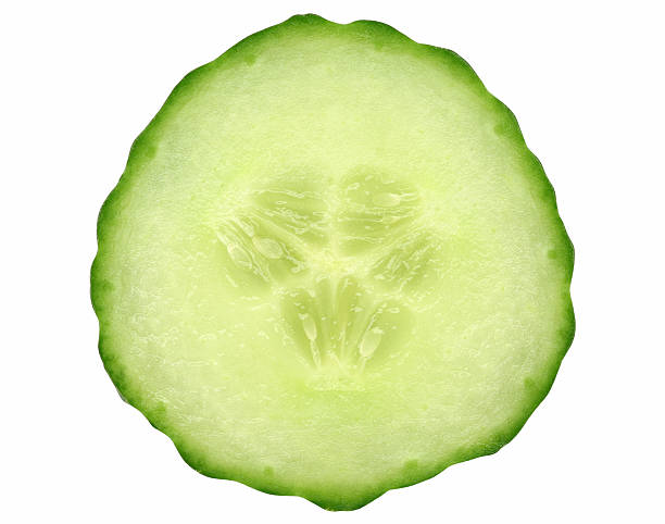 Close-up photo of a cucumber slice isolated on white A slice of fresh cucumber, isolated on white.  cucumber slice stock pictures, royalty-free photos & images