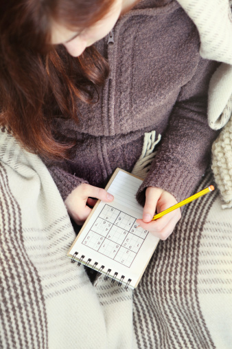 girl playing sudoku