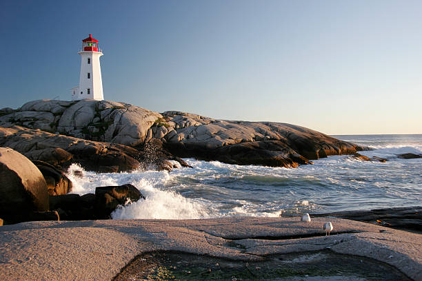 Peggys Cove Lighthouse & Waves Peggy's Cove Lighthouse in Nova Scotia, Canada maritime provinces stock pictures, royalty-free photos & images