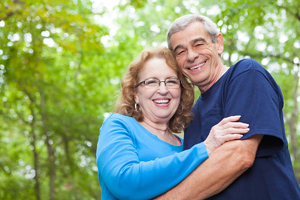 istock Happy senior retired couple hugging in sunny park 174895225