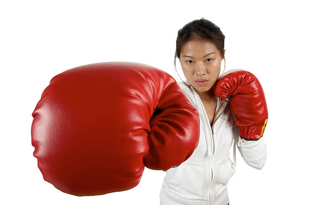 women boxing punching red gloves stock photo